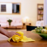 Female hand wiping dining table